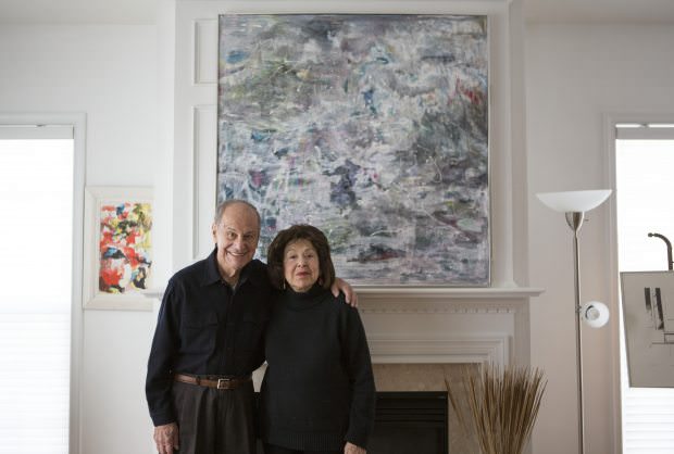 Painter Nelly Toll, a Holocaust survivor, right, and her husband Herb, in front of two of her recent paintings at their home in Vorhees, N.J., Jan. 20, 2016. Toll's work is part of the exhibition “Art From the Holocaust,” a showcase of 100 works clandestinely created by Jews in Nazi-occupied territories. Jessica Kourkounis/The New York Times 