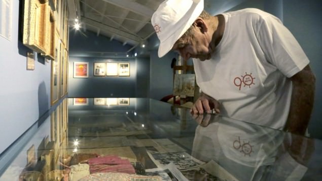 In this Thursday, Sept. 8, 2016 photo, Murray Greenfield, 90, looks around an exhibition about interned Jews at the Center of Visual Arts and Research in capital Nicosia, Cyprus. (AP Photo/Petros Karadjias)